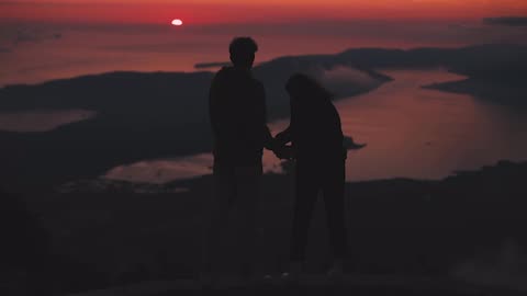 Couple kissing on mountain in evening