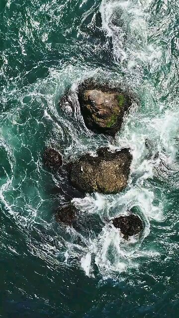 Birds Eye View of Crashing Waves on the Rock