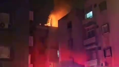 First Responders Attempt to Put Out a Fire After an Iranian Missile Strike