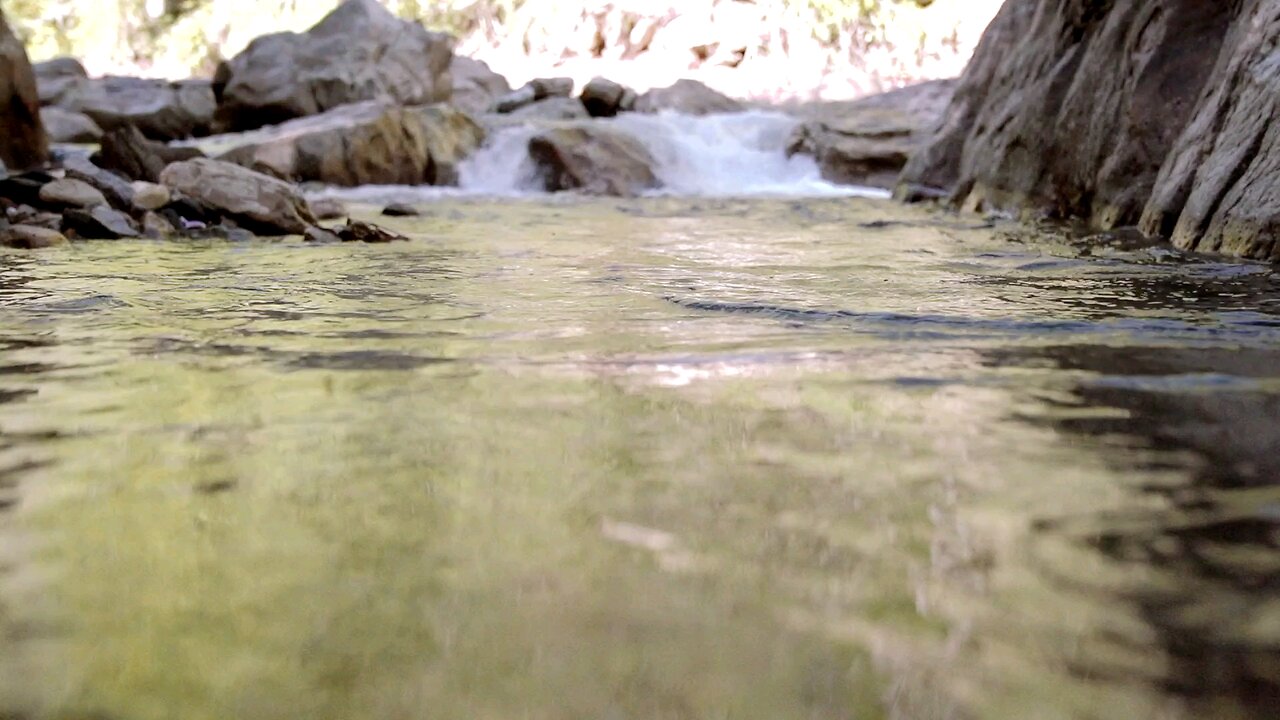 River Water Flowing Through Rocks