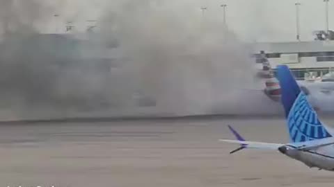 An aircraft from American Airlines is engulfed in flames at Denver International Airport.