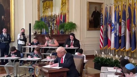 President Donald J. Trump signs an Executive Order to eliminate the Federal