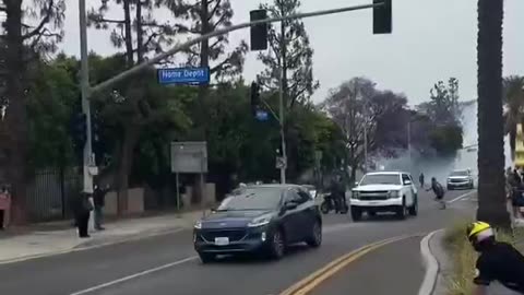 ICE protestors seen throwing rocks at passing vehicles