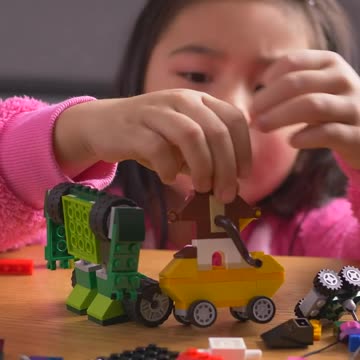 Little girl playing with her legos