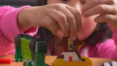 Little girl playing with her legos