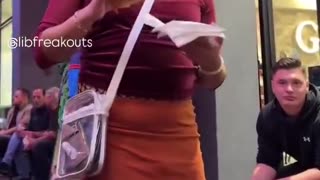 Man pretending to be a woman lectures woman wearing Native American Halloween costume