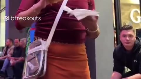 Man pretending to be a woman lectures woman wearing Native American Halloween costume