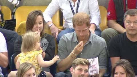 Sneaky toddler steals Prince Harry's popcorn