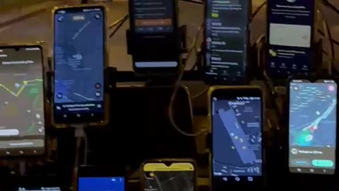 Taxi Driver With Eleven Phones On Windshield