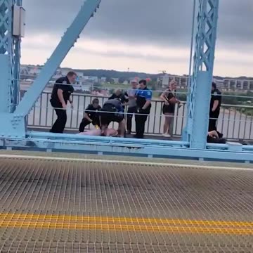 Officers clash with anti-ICE protesters on a bridge on the state line between Ohio and Kentucky