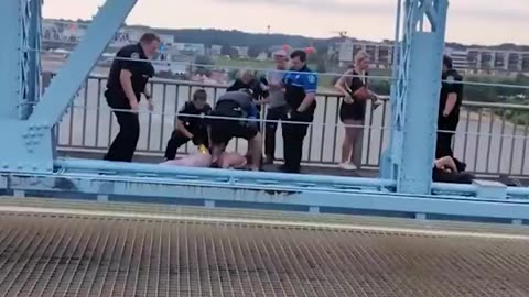 Officers clash with anti-ICE protesters on a bridge on the state line between Ohio and Kentucky