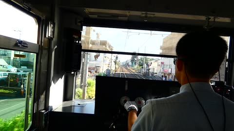 Directly behind the driver