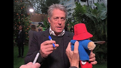 HUGH GRANT ⭐️ signs a Paddington Bear 🐻 for #charity / #WokingAndSamBeareHospice 🤍 3/11/24