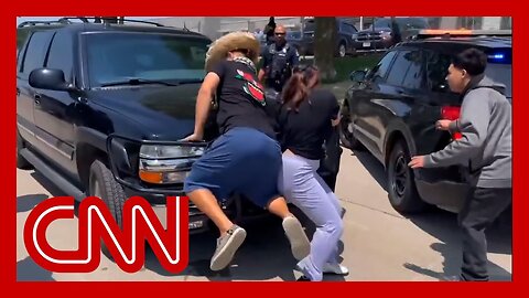 Employees block ICE cars with their bodies following meatpacking workplace raid
