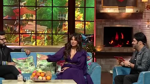 Does Kapil's wife not let Kapil's mother sit with her?