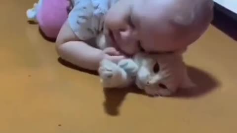 A cute children is playing with cute cat