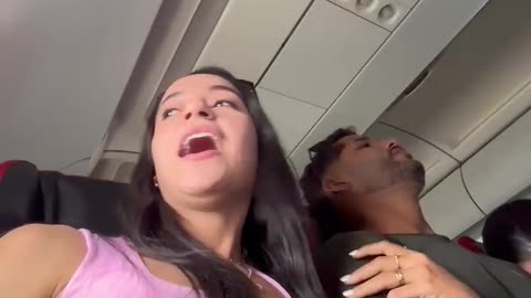 Woman Hugs Arm of Someone Else's Husband During Turbulence