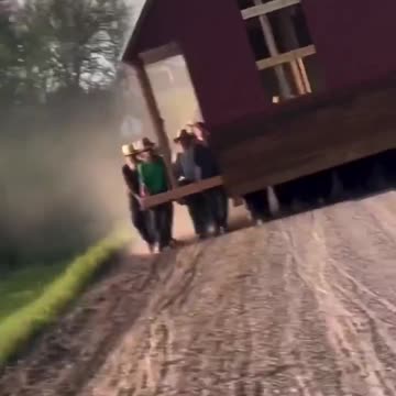 50 Amish men and their kids carrying a small barn over a mile down a dirt road in Pennsylvania.