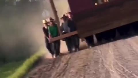 50 Amish men and their kids carrying a small barn over a mile down a dirt road in Pennsylvania.