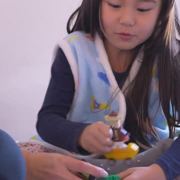 Little girl playing with her mom
