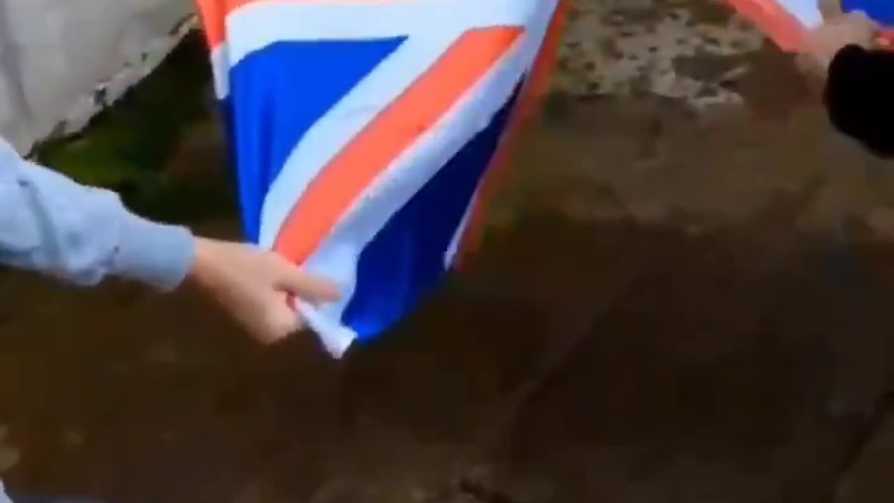 Muslim immigrants in the UK were filmed ripping up a British flag while...