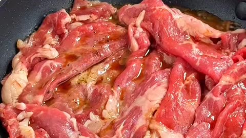 Making rice with sliced beef on top and some meats for dinner