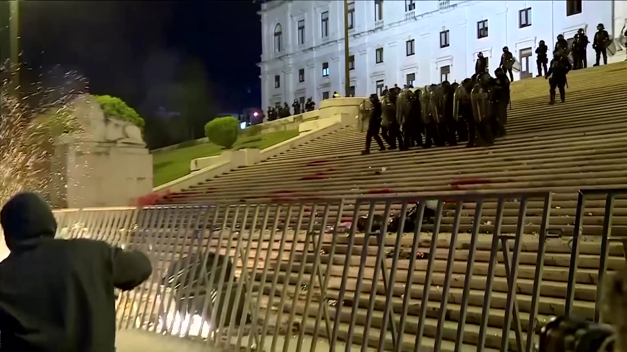 Portuguese demonstrators throw projectiles during general strike