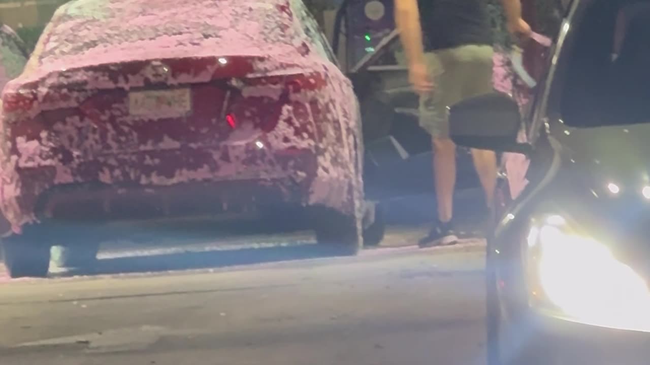 Man Washes Car Interior With Hose