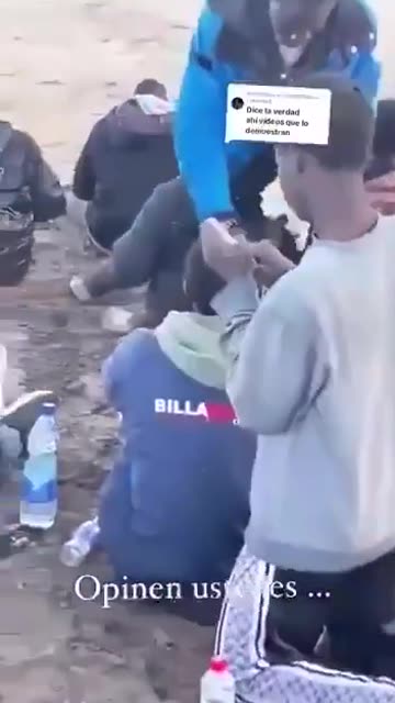 Footage has surfaced of illegal migrants being handed out free mobile phones