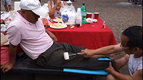 Luodong Massages Mexican Man's Leg With Oil And Tools