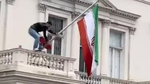 London Activist Scales The Iranian Embassy, Replacing Flag with Pre-Islamic Republic One