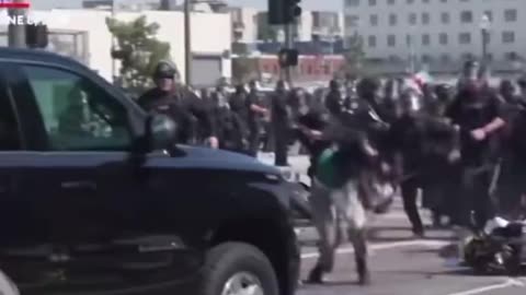 Anti-ICE rioter drives a motorbike directly into LAPD riot police; assaults an officer