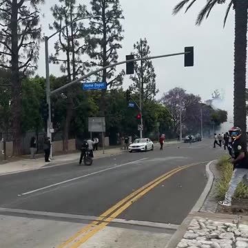 Protester caught on camera throwing rocks at unmarked federal vehicles in Paramount, California.