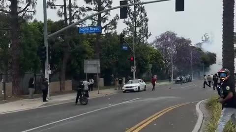 Protester caught on camera throwing rocks at unmarked federal vehicles in Paramount, California.