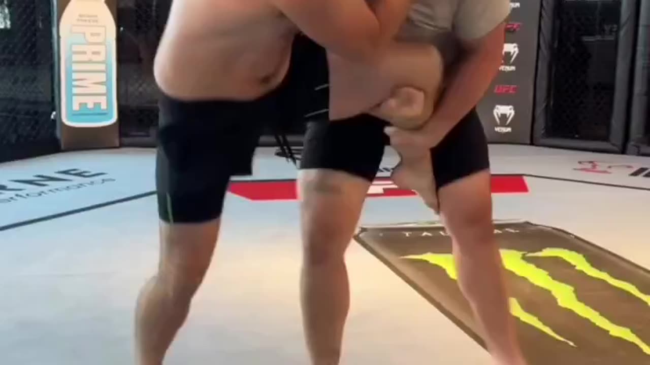 Sean Strickland wrestles with NFL offensive lineman Dylan Fairchild.