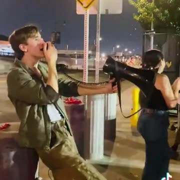 singing into a megaphone “We got Charlie in the neck & clap and cheer for Charlie Kirk’s murder