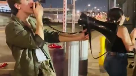 singing into a megaphone “We got Charlie in the neck & clap and cheer for Charlie Kirk’s murder