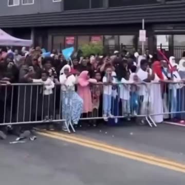 Minneapolis Mayor Jacob Frey waves the Somali flag and leads a chant in a foreign language on stage