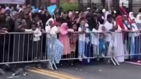 Minneapolis Mayor Jacob Frey waves the Somali flag and leads a chant in a foreign language on stage