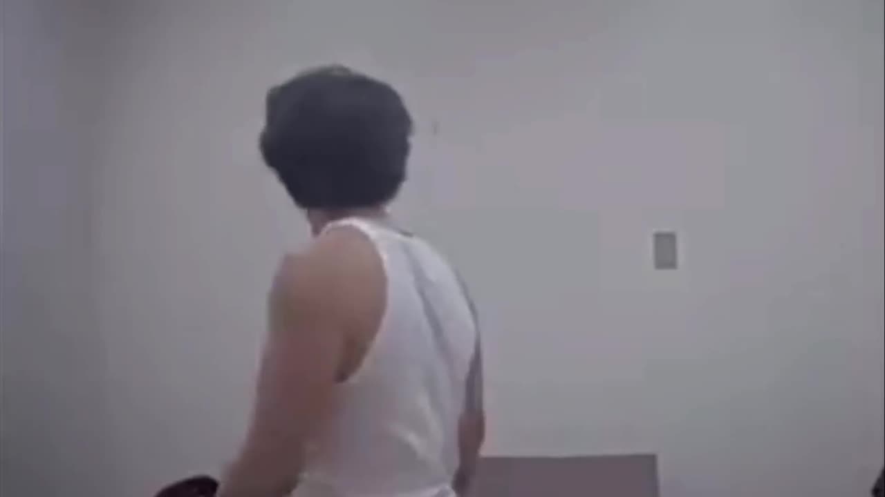 Man escapes the interrogation room by kicking a whole in the wall.