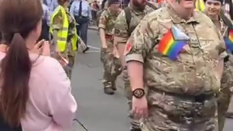 Fat and female British army marching in a gay parade