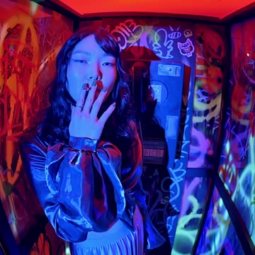 Asian Woman on Graffiti Phone Booth