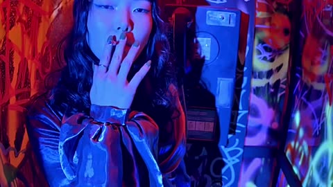 Asian Woman on Graffiti Phone Booth