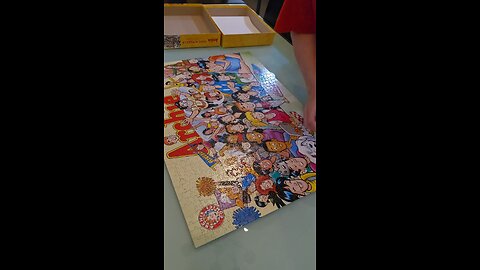 Putting my Archie puzzle back in the box after completing it.