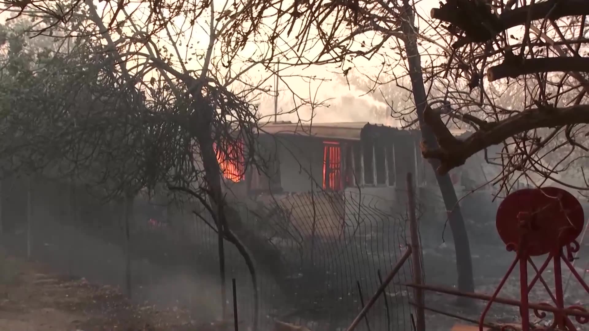 Greek residents defend homes as wildfire tears through village