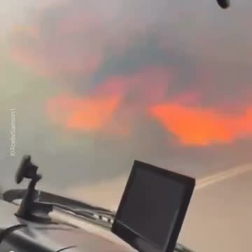 Raging wildfire seen through a windshield as forest fires escalate in Israel