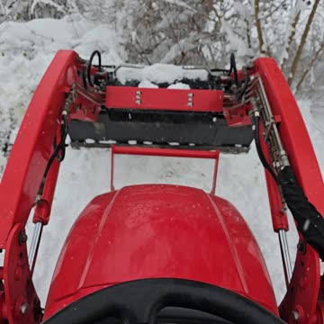 Kioti tractor plowing snow.