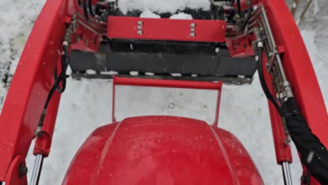 Kioti tractor plowing snow.