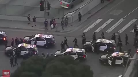 LAPD column arrives in downtown Los Angeles, California amid ongoing "ICE Out" protests.