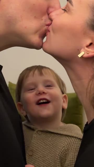 Mom and Dad Kissing in Front of Their Child